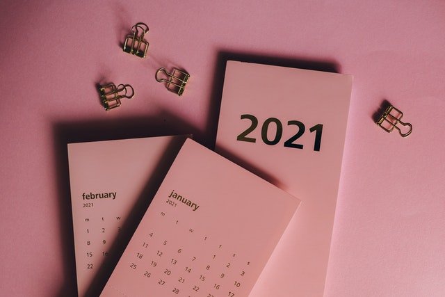 2021 January and February calendar on a pink surface