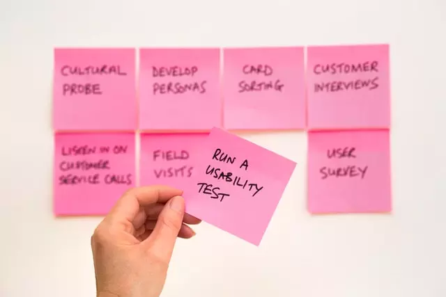 Pink sticky notes with project notes