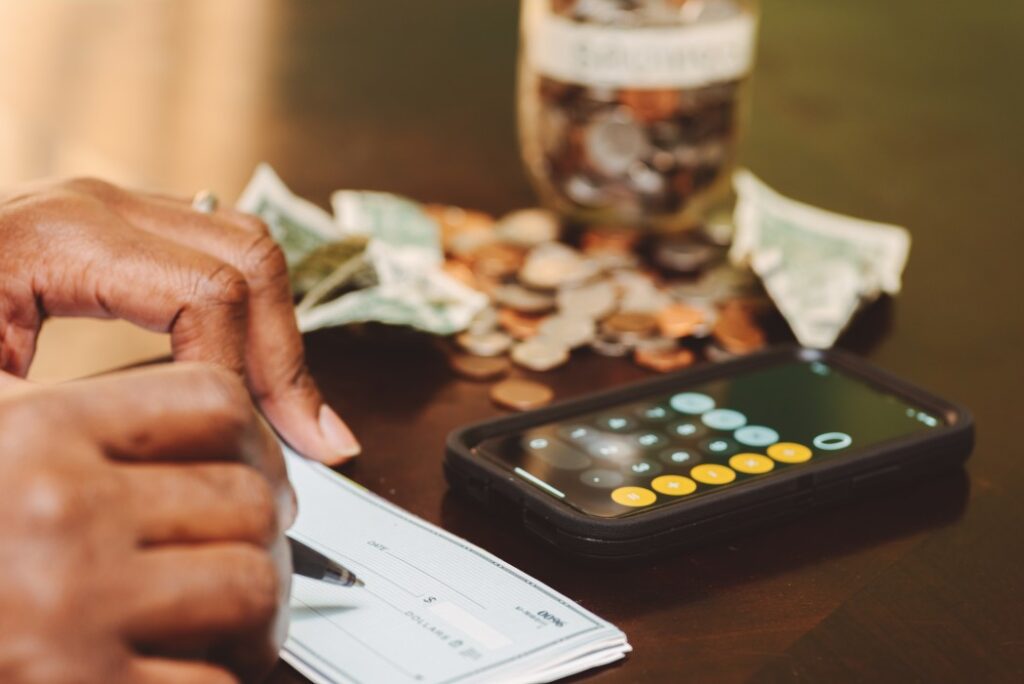 man counting money and writing check